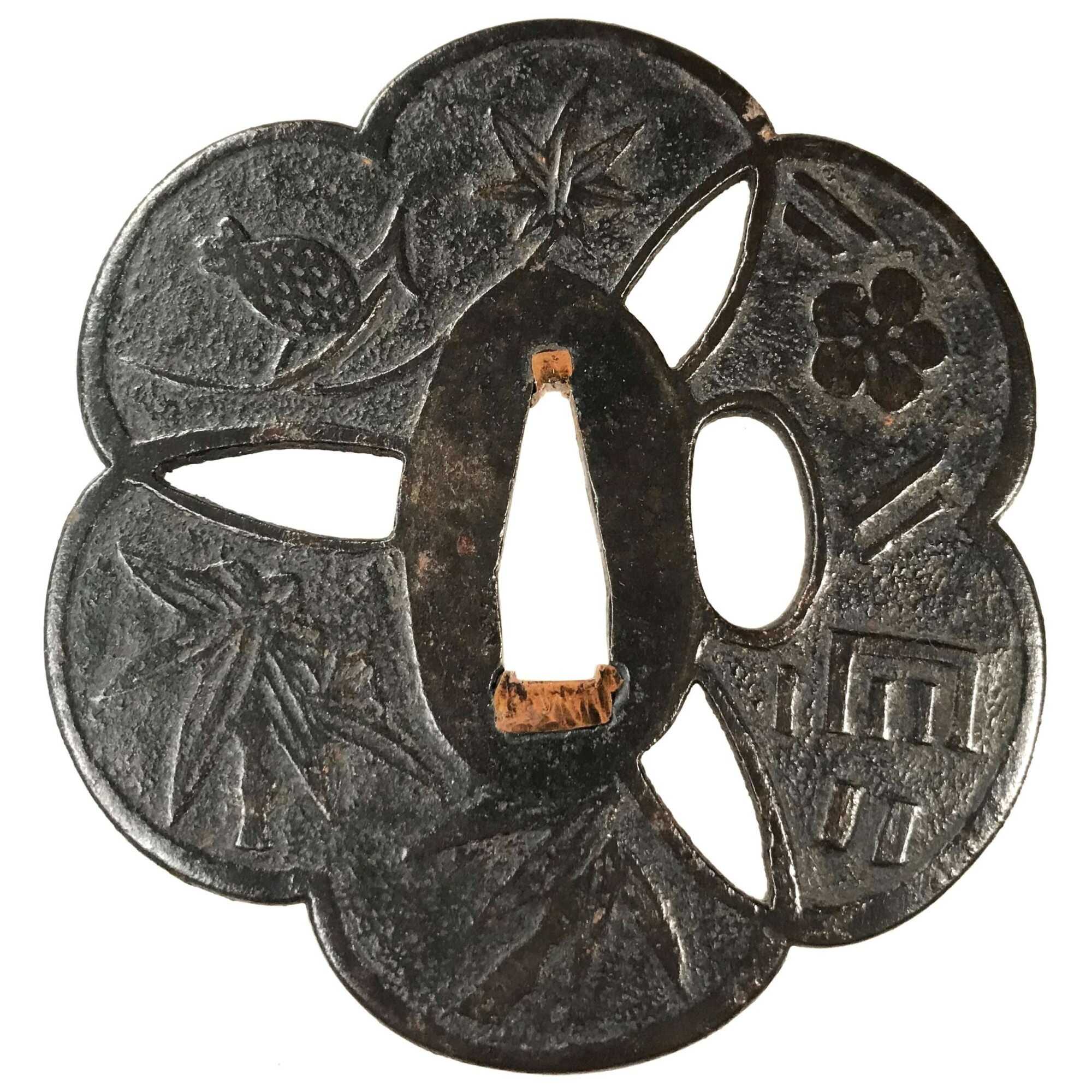 A metal tsuba (sword guard) featuring a bird (sparrow) perched on bamboo branches, and several other designs including leaves (foliage) and flowers (blossoms). The central cut-out is keyhole-shaped, surrounded by engraved motifs variously distributed across the circular guard."