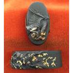 Fuchi-kashira with designs of eagle holding a monkey, and young monkey sheltering under a tree.