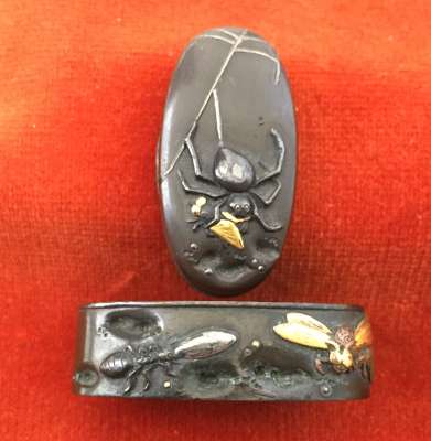 Fuchi-kashira with designs of spider holding a fly, and other insects.