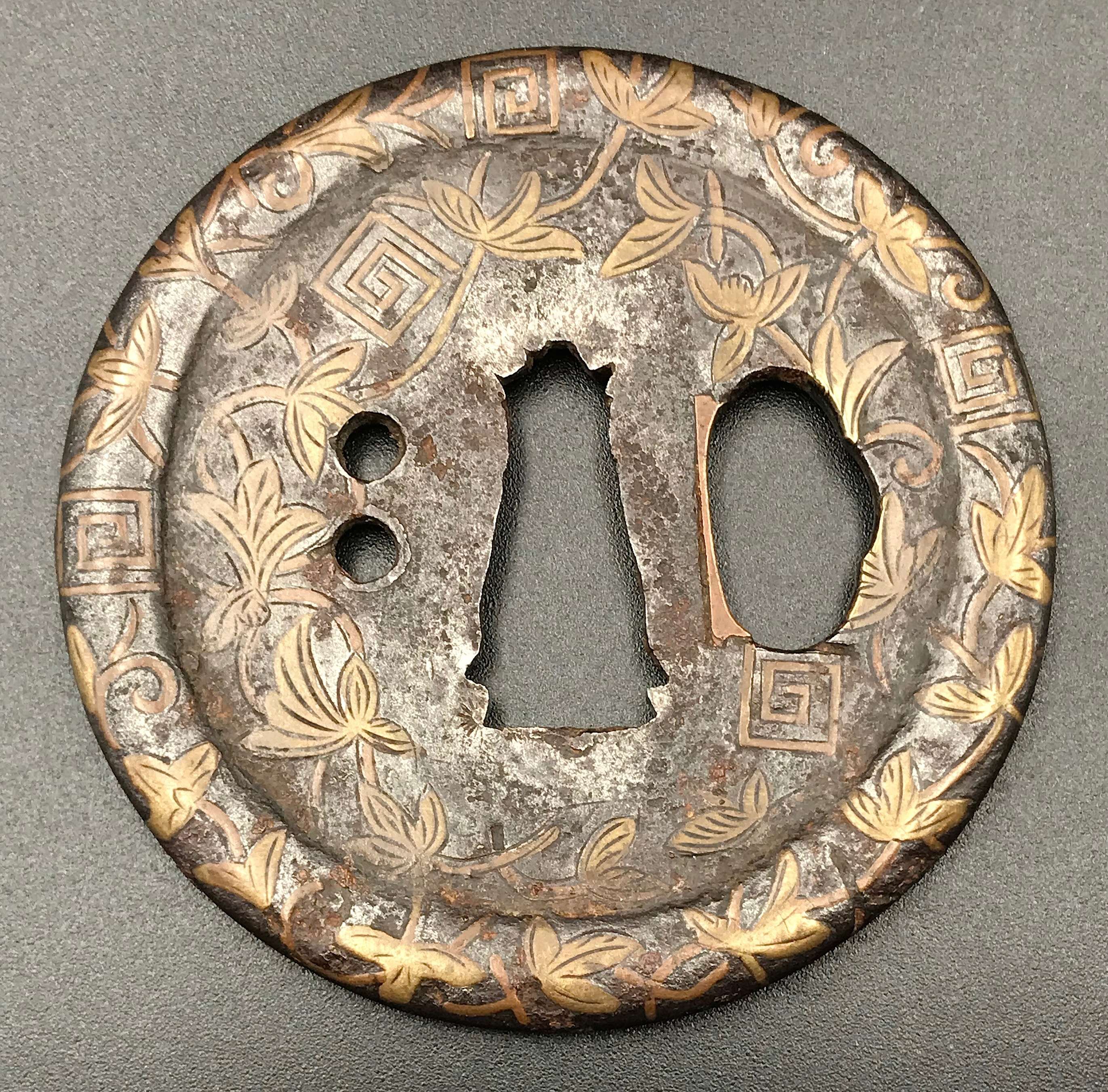 Brass hira-zōgan iron tsuba with design of vines and thunder. Muromachi