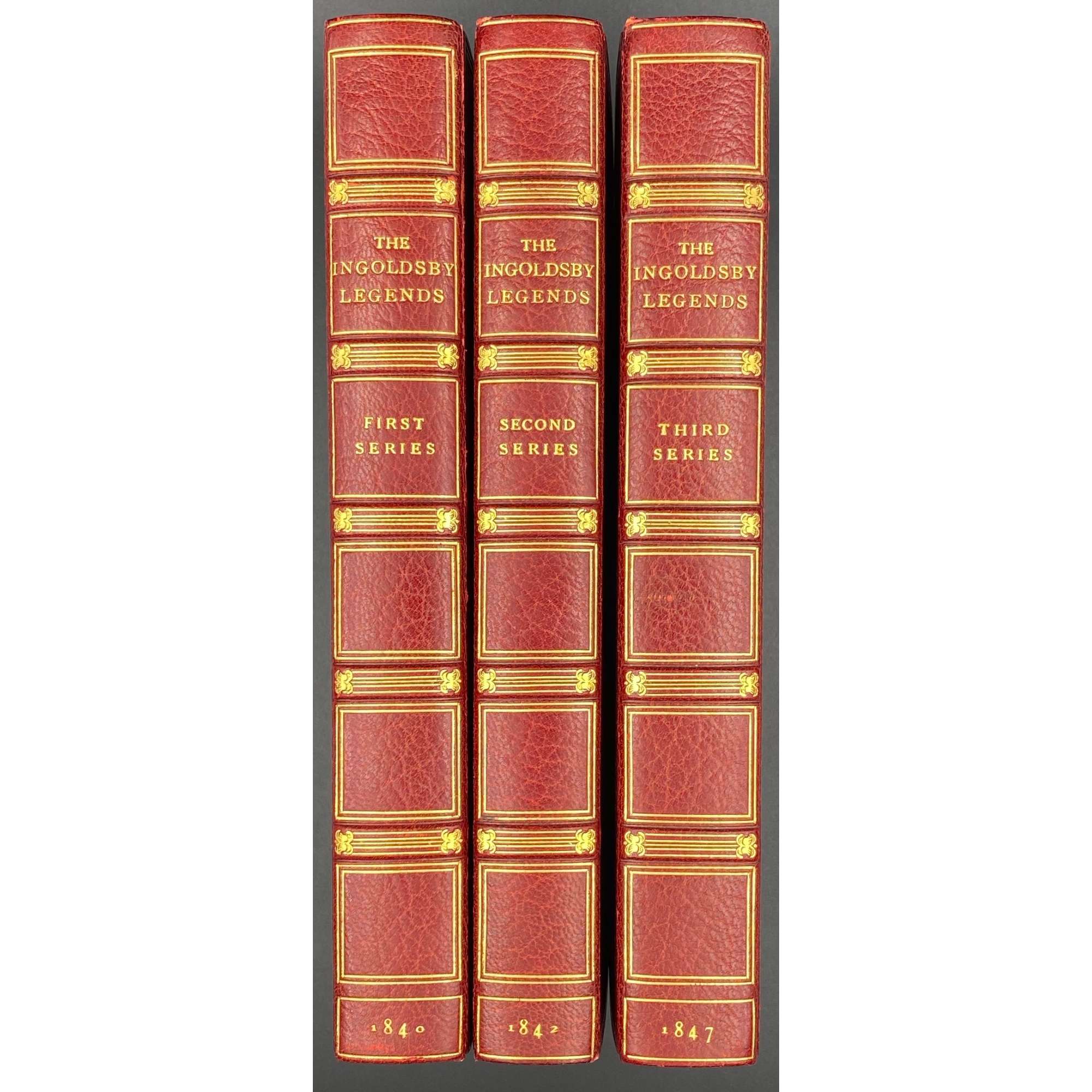 [Barham, Richard Harris]. The Ingoldsby Legends or Mirth and Marvels by Thomas Ingoldsby, esquire / First, Second and Third Series - 3 volumes; Illustr.: George Cruikshank and John Leech. — London: Richard Bentley, 1840-1847. — Vol. 1: Printed by London: Samuel Bentley, 1840. pp.: ff, [2 blank] [i ht] [ii colophon] [title, verso blank] [iii] iv-v [vi blank] [contents, list of ill.] [blank, etching on verso] [1] 2-338 [339] [7, incl. orig. FC and Sp.] bf, 6 plates: 1 by Buss, 3 by Leech, 2 by Cruikshank. — Vol. 2: Printed by London: S. & J. Bentley, Wilson, and Fley, 1842. pp.: ff, [2 blank] [i ht] [ii colophon]  [title, verso blank] [v] vi-vii [viii blank] [contents, verso blank] [blank, etching on verso] [1] 2-288 [6, incl. orig. FC and Sp.] bf, 7 plates: 3 by Leech, 4 by Cruikshank. — Vol. 3: Printed by London: S. & J. Bentley, Wilson, and Fley, 1847. pp.: ff, [2 blank] [i ht] [ii colophon] [title, verso blank] [iii] iv-vi [contents, list of ill.] [blank, portrait on verso] [1] 2-364 [6, incl. orig. FC and Sp.] bf, 6 plates: 2 portraits, 2 by Leech, 2 by Cruikshank.