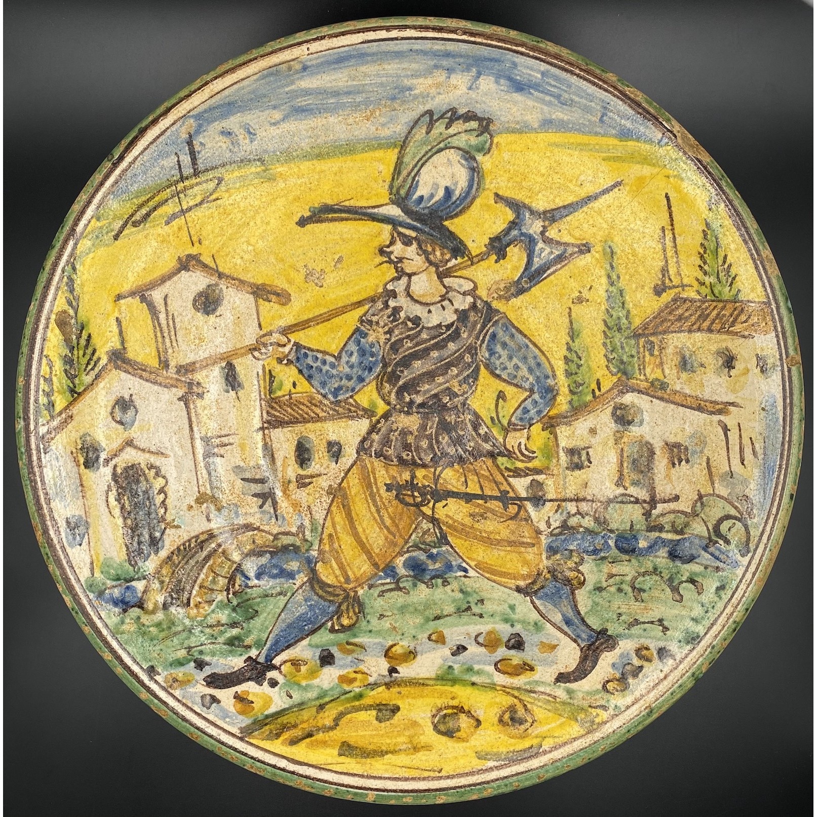 Montelupo maiolica charger with a gentleman in landscape holding a halberd (Italy, 17th century).